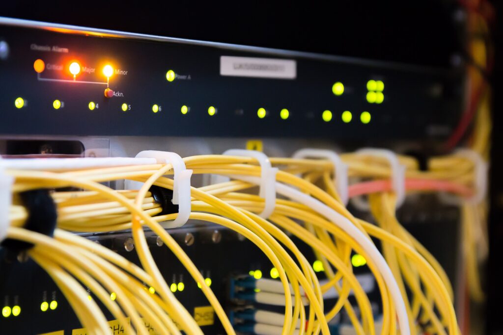 Networking equipment with yellow fiber running along the front
